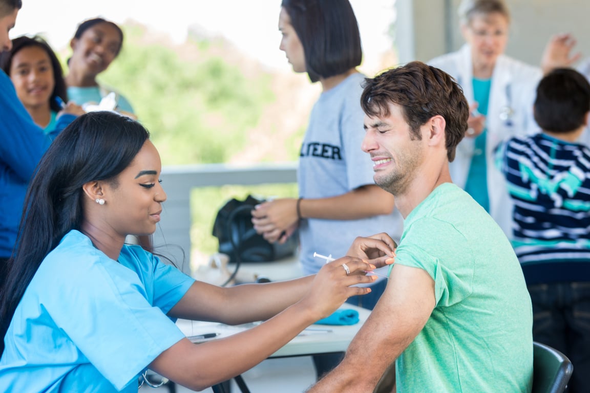 Man receives flu vaccine during health fair